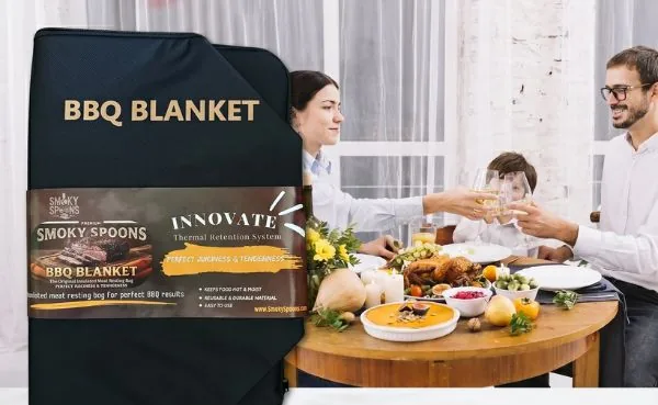 Family toasting at the table next to a freshly served turkey and the Smoky Spoons BBQ Blanket